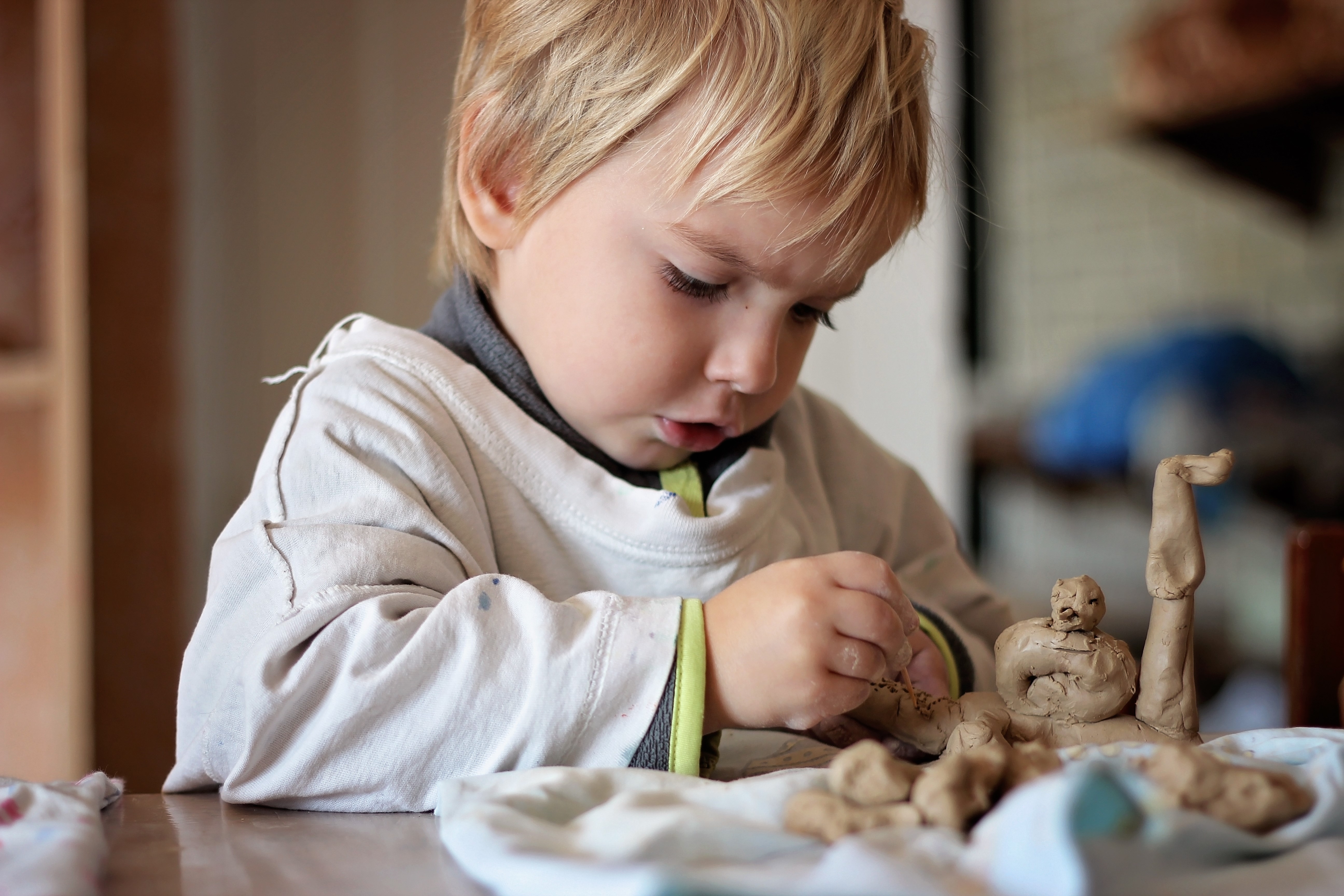 child molding clay figures for holiday