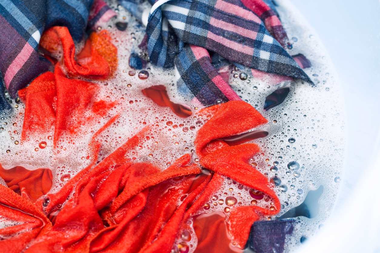 washing and soaking clothes in laundry detergent
