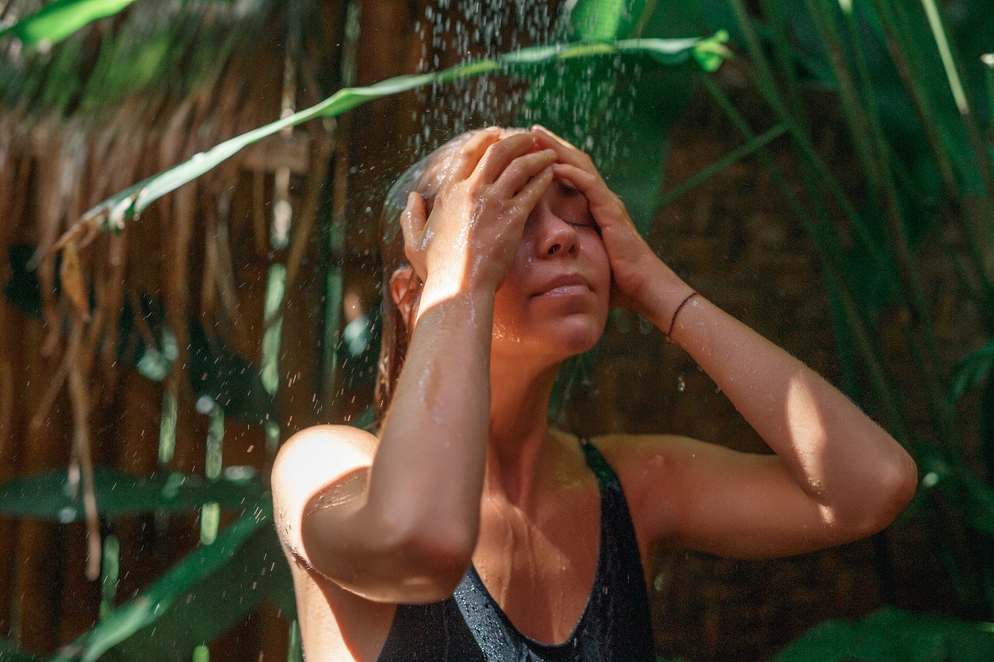 woman rinsing her bathing suit in the shower