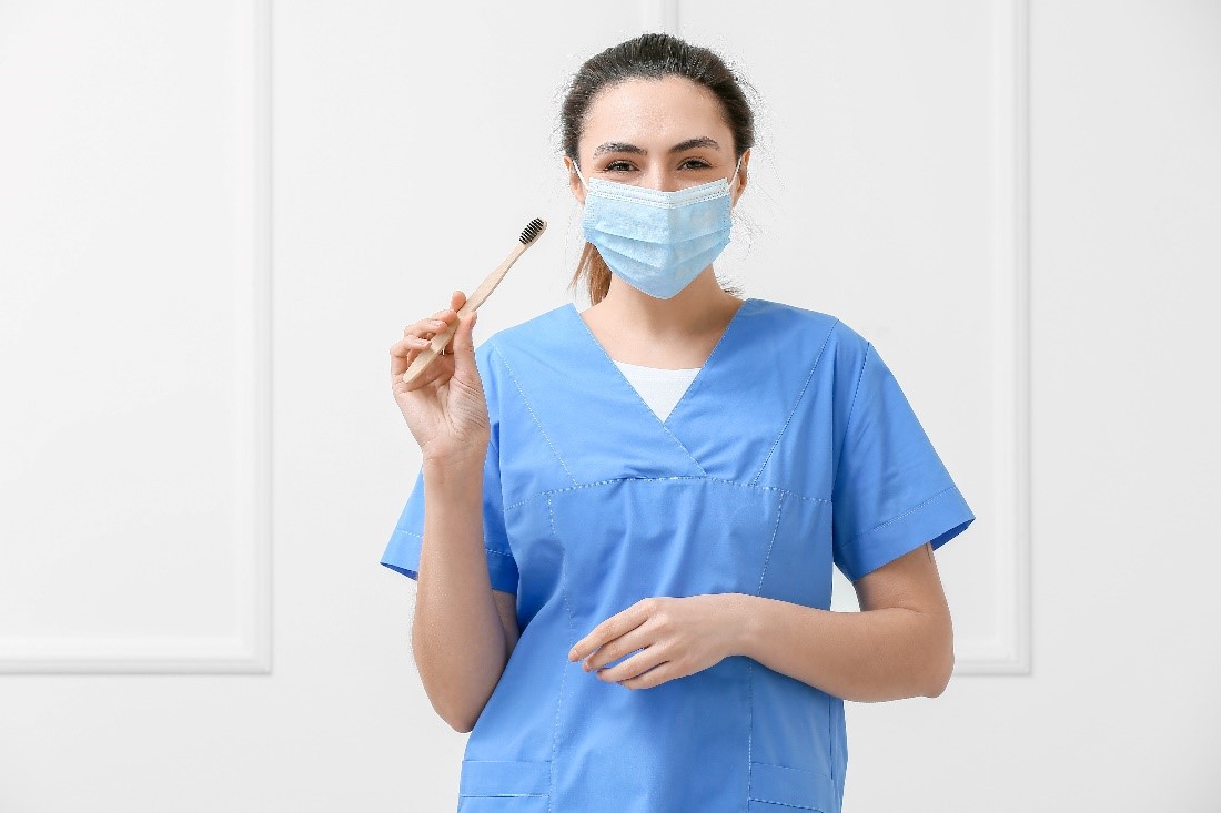 female dentist with toothbrush dental care cleaning
