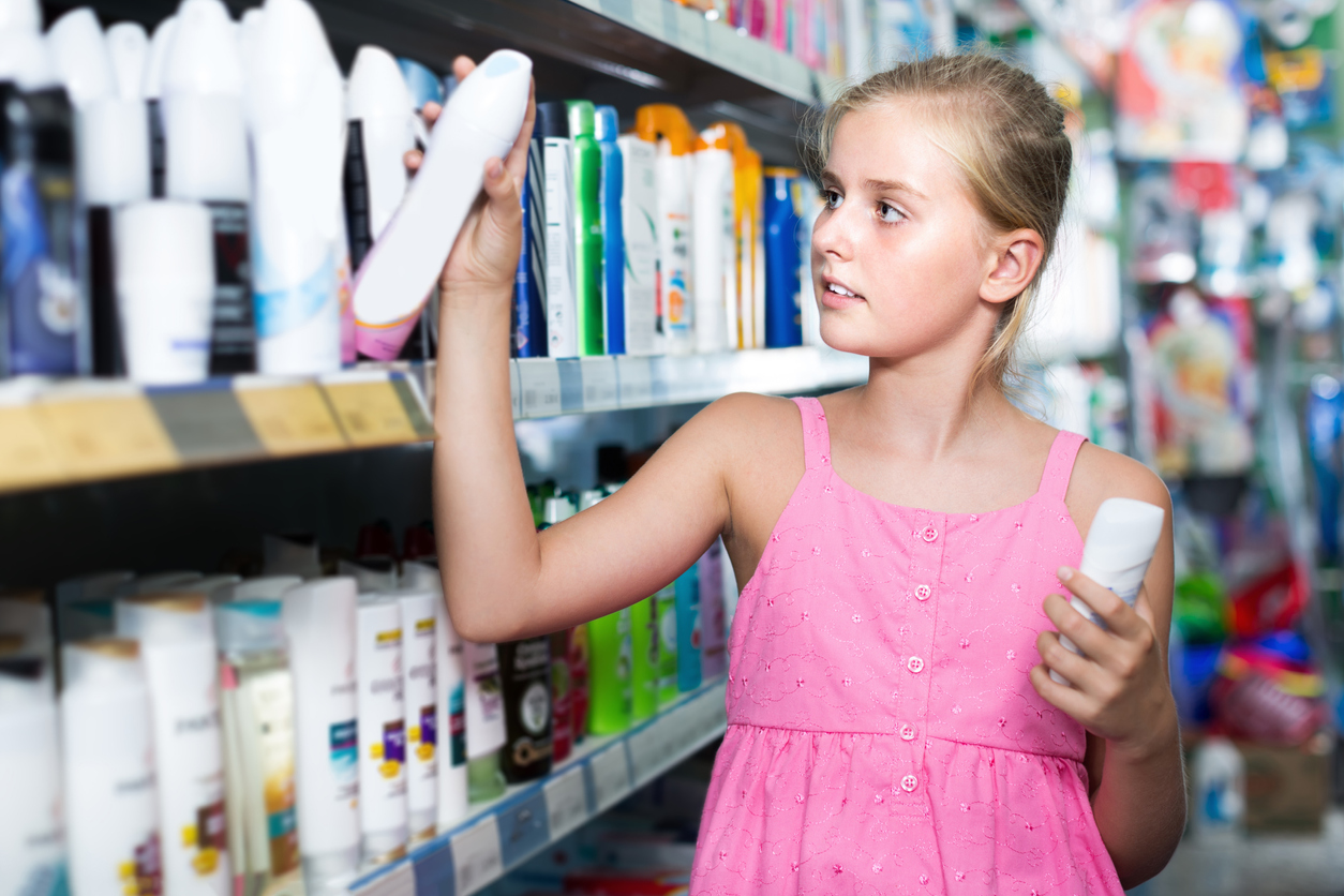 Teen girl choosing an antiperspirant or deodorant