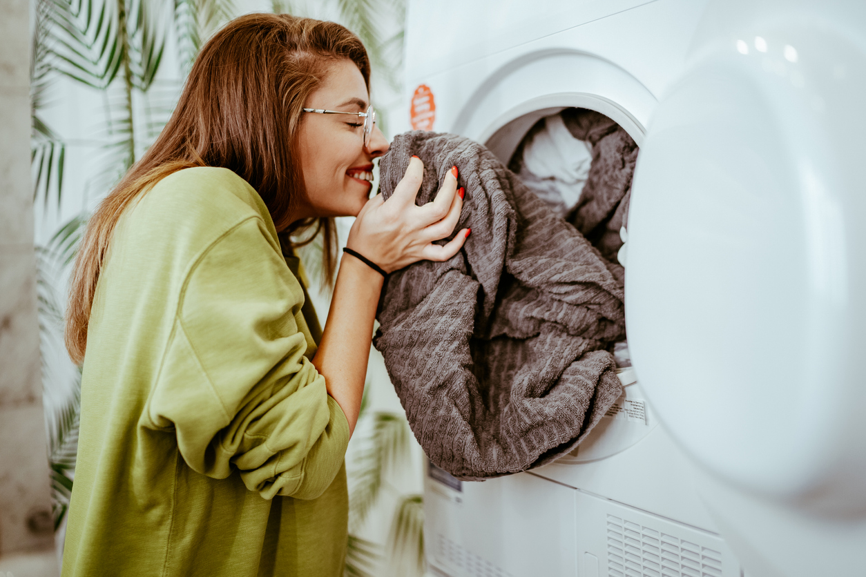 Woman smelling clean laundry