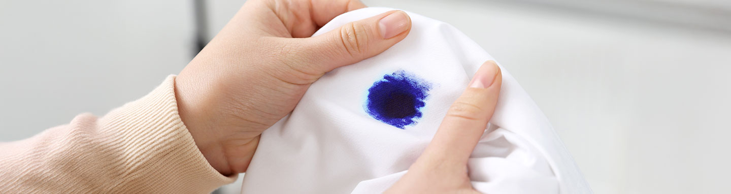Blue ink stain on a white shirt.
