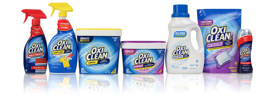 Lineup of OxiClean laundry additive powders, liquid laundry boosters, power paks, and pretreatment sprays.